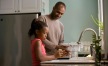 a person and a girl washing dishes